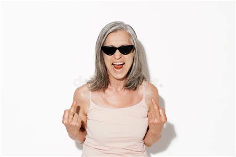 Mature Woman In Sunglasses Grimacing While Showing Peace Sign At Camera