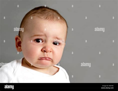 Distressed 11 Month Old Frowning Baby Boy About To Cry Stock Photo Alamy