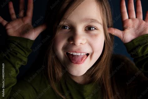 Cute Smiling Little 9 Year Old Girl Showing Her Tongue Stock Photo