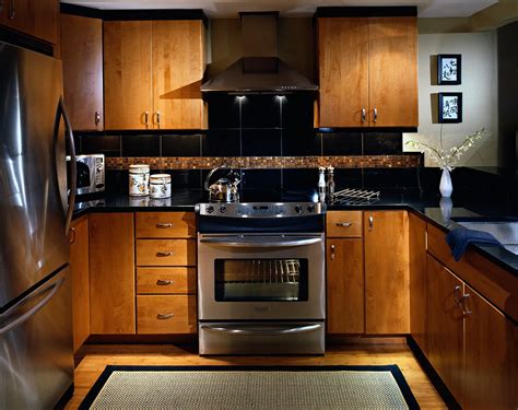Maple is a popular choice for kitchen cabinets. Condo kitchen with Asian feel. Slab maple cabinet doors ...