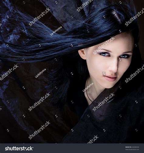 Young Beautiful Girl With Black Hair And Blue Eyes Stock