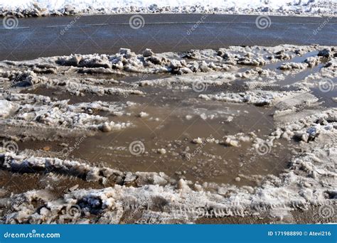 Snow Is Melting Dirty Puddles In The Street Stock Photo Image Of