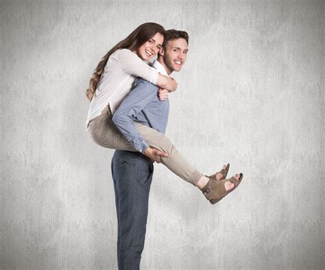 Composite Image Of Portrait Of Smiling Man Carrying Woman Stock Photo