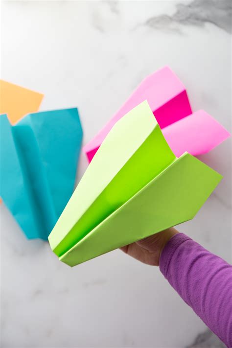Flip it over and fold it back over this fold as closely to the same size as possible. How to Fold the Best Paper Airplane - The Crafting Chicks