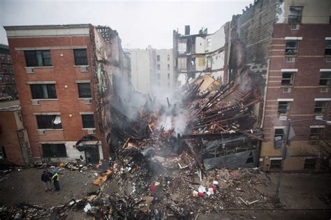 New York City firefighters work at the site of a building explosion and