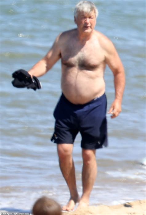 Alec Baldwin Shows Off Shirtless Physique As He Frolics Across The Beach In The Hamptons