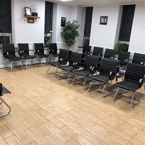 Patients sitting in chairs waiting appointment time at hospital doctor consultation. Cantilevered visitor waiting chairs project in New Jersey ...
