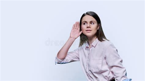Young Curious Woman Listening Holding Hand Near Ear White Background