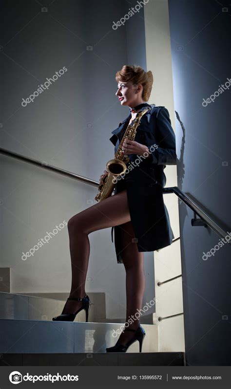 Sexy Attractive Women With Saxophone And Long Legs Posing On Stairs