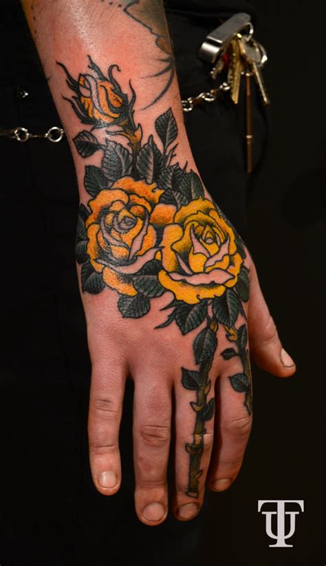 This pretty red rose with dark petals, sitting on the shoulder of the girl, oozes a carved on the foot; Tattoo Union: Rose Hands