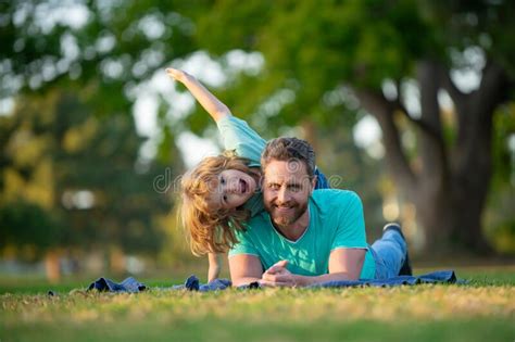 Happy Father And Son Enjoying Summer Time On Vacation In A Sunny Park Concept Of Healthy