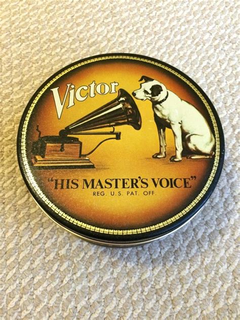 A Tin With An Image Of A Dog On Its Side And The Words His Masters Voice