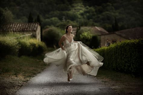 Elegant Photo Of Bride Running Along Garden Path By David Bastianoni