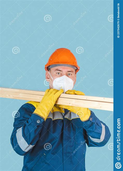 The Carpenter Holds Wooden Planks On His Shoulders A Construction