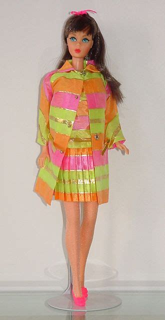 A Barbie Doll Wearing A Colorful Dress And Pink Shoes
