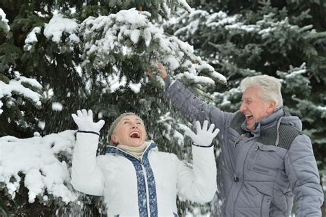 Premium Photo Happy Senior Couple At Snowy Winter Park