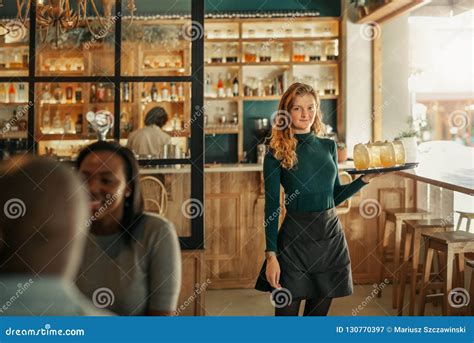 Smiling Bar Waitress Standing With A Tray Of Drinks Stock Image Image Of Eatery Bistro 130770397