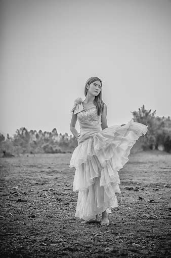 Asia Beautiful Woman In Yellow Dress Stand On Field Stock Photo