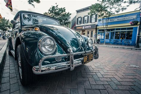 Green Volkswagen Beetle Parked On Sidwalk · Free Stock Photo