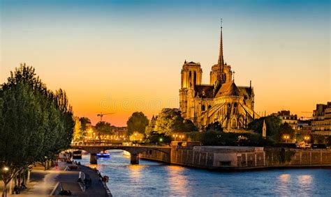 Gorgeous Sunset Over Notre Dame Cathedral With Puffy Clouds Stock Image