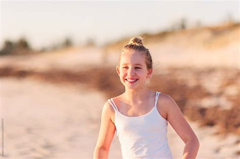 Smiling Pre Teen Girl At The Beach At Sunset By Stocksy Contributor Angela Lumsden Stocksy