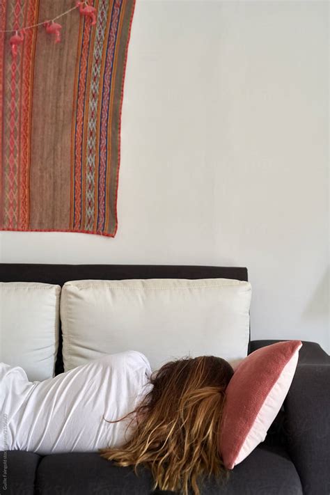 girl sleeping on sofa by stocksy contributor guille faingold stocksy