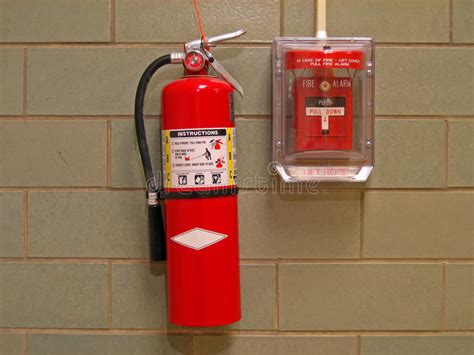 Every fire victim probably thought it would never happen to them. Fire Extinguisher And Alarm 2 Stock Image - Image: 1560485