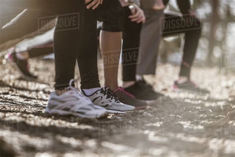 Close Up Of Runners Stretching In A Row Stock Photo Dissolve