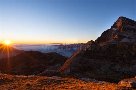 Mountain Range At Sunset Backlight With Sunburst Italian Alps Stock