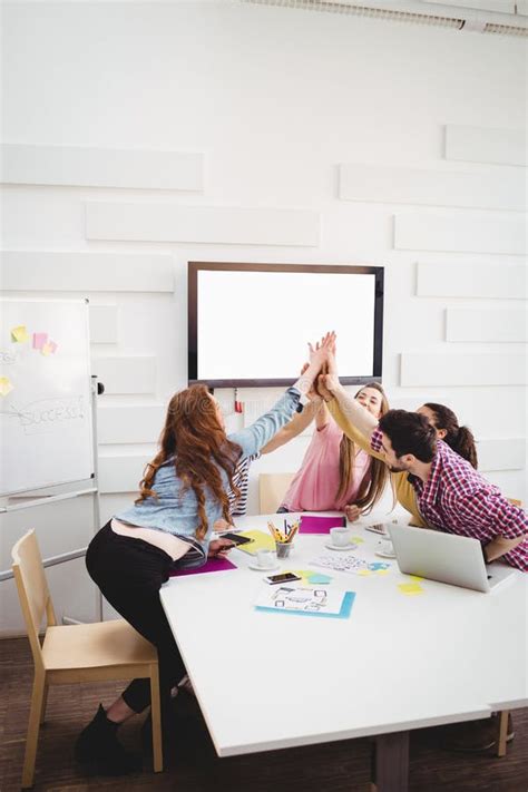 Happy Executives Giving High Five In Meeting At Creative Office Stock