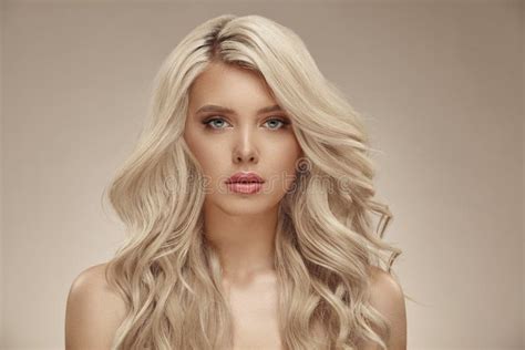 Pretty Young Blonde Woman With Nude Makeup Has A Curly Long Bright Hair
