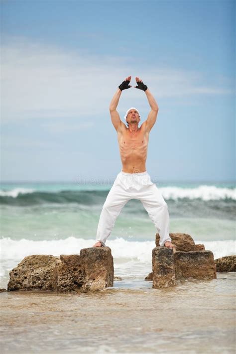 Healthy Man Doing Pilates Yoga Meditation On Beach Summer Stock Photo