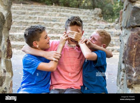 Two Younger Brothers Gang Up On Older Brother Playfully Stock Photo Alamy
