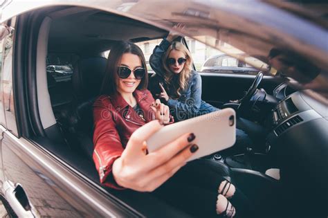 Group Of Girls Having Fun With The Car Taking Selfie While Driving In