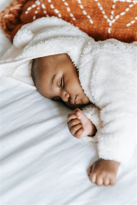 Adorable African American Baby Sleeping On Comfy Bed · Free Stock Photo