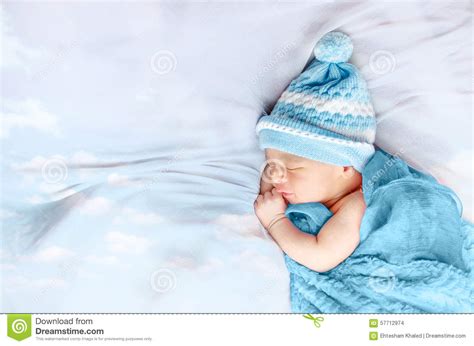 Newborn Baby Boy Sleeping On White Silk Bed Floating Clouds Stock Photo
