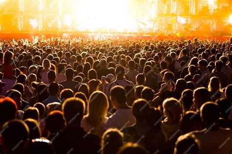 Premium Photo Audience At A Music Festival And Lights Streaming Down