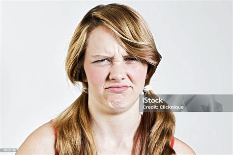 Portrait Of Scowling Grumpy Teenage Girl Stock Photo Download Image