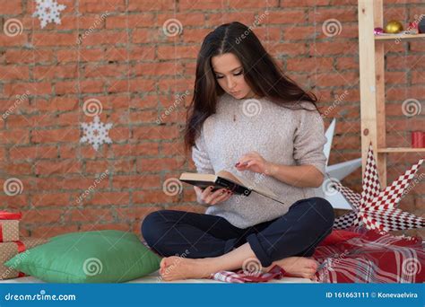 Closeup Portrait Young Woman In Blue Tanktop Reading Book On Bed Stock