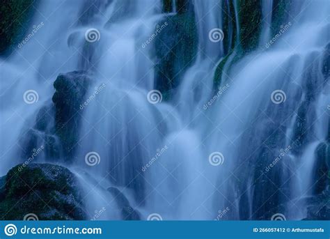 Beautiful Mountain Rainforest Waterfall With Fast Flowing Water And