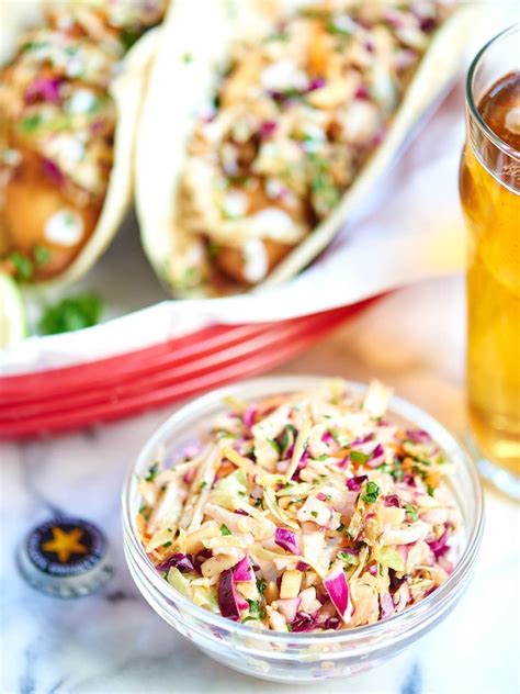 These delicious beer battered crispy fish tacos are a new twist on a baja classic! Beer Battered Fish Tacos - Fried Cod Tacos w/ Asian Slaw