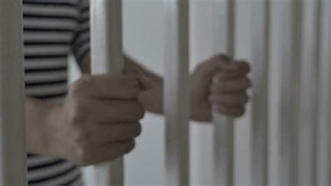 4k Hands Of Asian Prisoner Behind Jail Stock Footage Sbv 301566612 Storyblocks