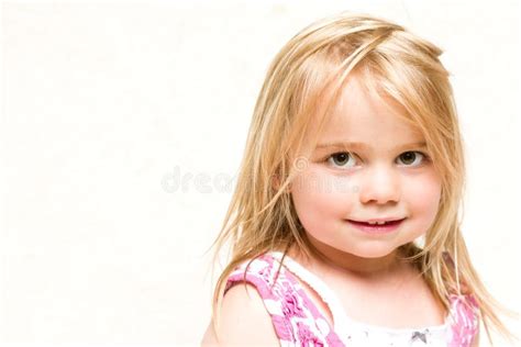 Portrait Of Beautiful Smiling Toddler Girl With Blonde Hair Stock Photo