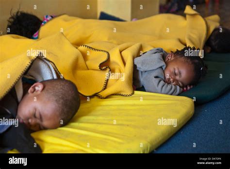 Young South African Children Lie Down On Mats For A Sleep During Rest