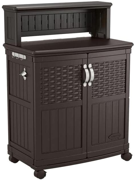 An Outdoor Storage Cabinet With Doors And Drawers On Wheels In Dark