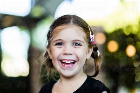 Image Of Portrait Of Happy Little Six Year Old Girl Laughing With Bokeh