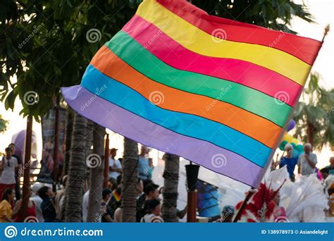 Waving Rainbow Of Gay Flag And Crowd Of People In Pride Rainbow
