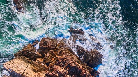 Waves Crashing Into Rocky Coasts Of Maine Aerial From Above Looking