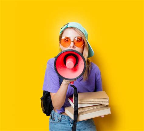 Girl In Purple Clothes With Pink Megaphone And Books Stock Image