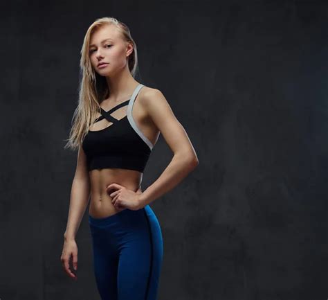 Sexy Slim Blonde Girl In A Sportswear Posing In A Studio Stock Photo